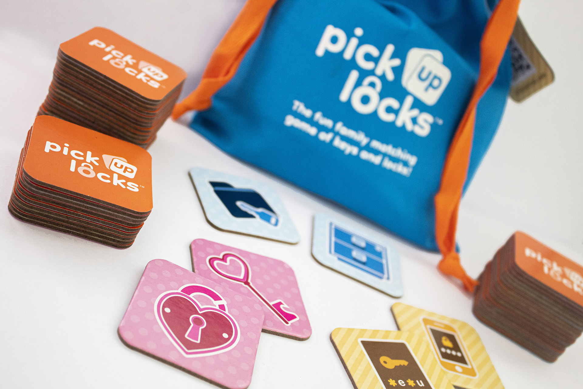 A bag of Pick Up Locks with tiles stacked in front of it, along with some paired tiles.